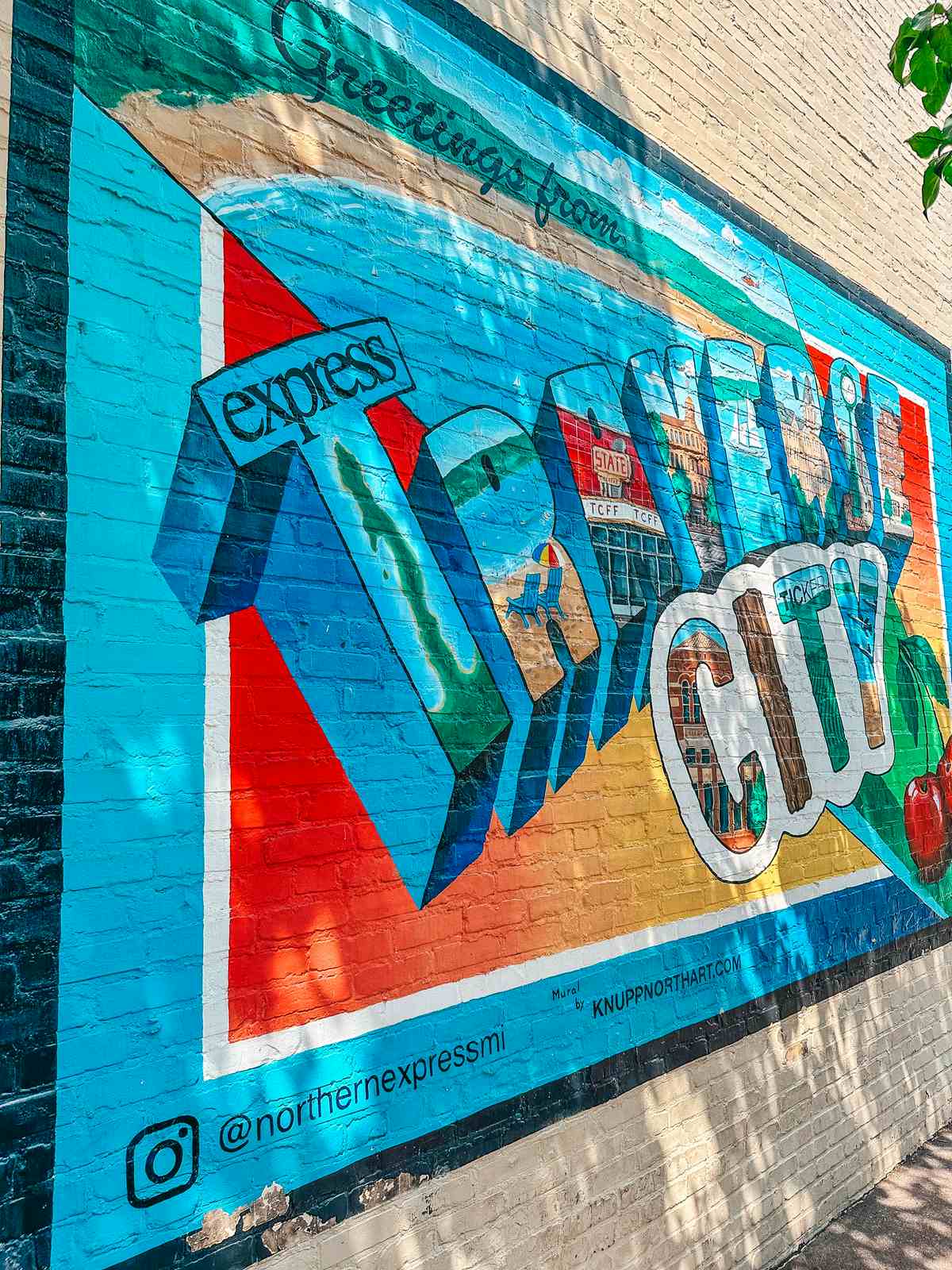 The iconic 'Greetings from Traverse City' mural welcomes visitors to a city full of adventure and charm.